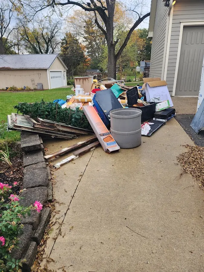 Dumpster being loaded with debris for 12 Yard Dumpster Rental in Haddon Heights